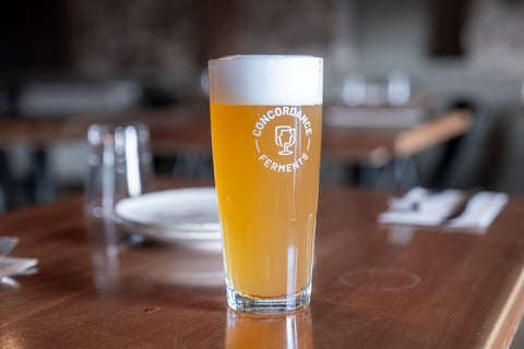 Afternoon Tea, a hazy Nordic table beer, poured in a Concordance Ferments glass