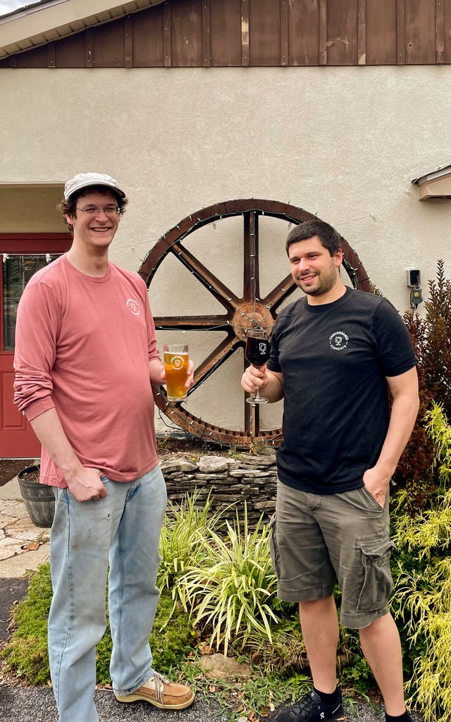 Concordance Ferments owners Dave and Abe outside the mill beside the old water wheel