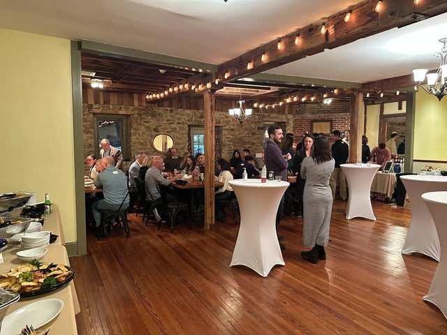 The same third-floor event space laid out for a standing reception with cocktail tables and mingling room