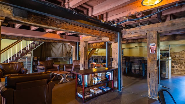 The lounge and bar area at Concordance Ferments with leather seating and reclaimed timber